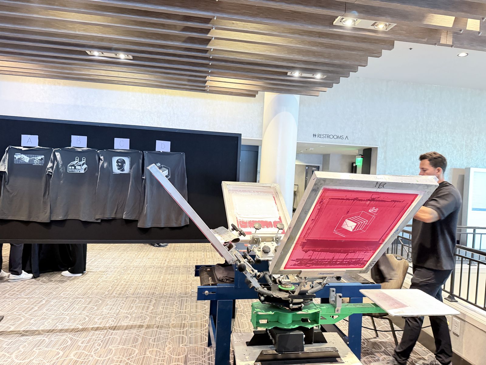 Merch Troop live screen-printing station running at a Columbus event